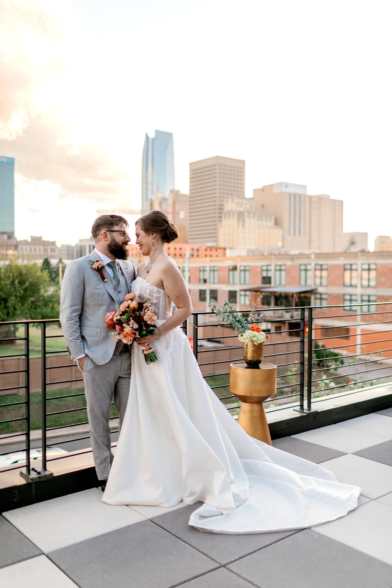 Dr. Allison Brewer with her husband David on their wedding day, downtown Oklahoma City skyline behind them